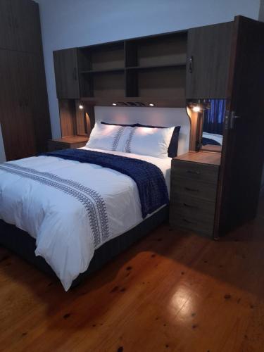 a bedroom with a large bed with a wooden headboard at 105 on Sarel Cilliers in Strand
