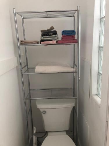 a towel rack over a toilet in a bathroom at Seabreeze Three Bedroom Home in Rochester