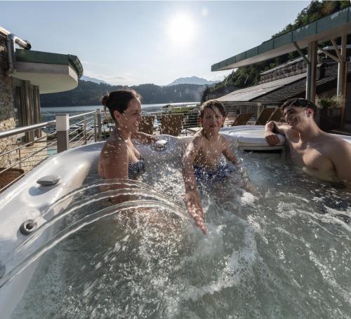 a group of people in a jacuzzi tub at Parc Hotel Du Lac in Levico Terme