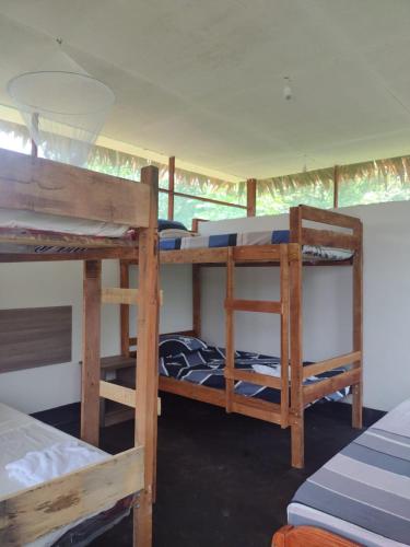 a room with three bunk beds in a house at Amazon Macambo Lodge in Iquitos
