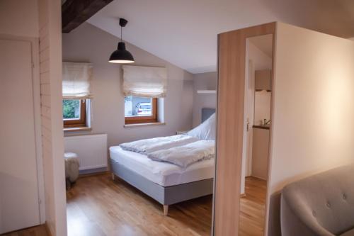 a small bedroom with a bed and a mirror at Erika´s Häuschen in Kitzbühel