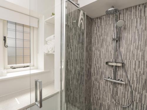 a shower in a bathroom with a glass wall at The Grooms Flat in Malmesbury