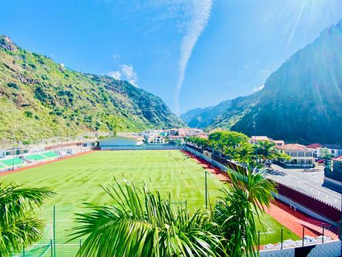 a soccer field with mountains in the background at VALE MAR Guest in Ribeira Brava