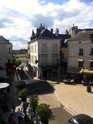 a group of people sitting in a courtyard in a city at Villa Roma B&B in Amboise