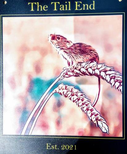 a picture of a bird sitting on a plant at TAIL END: Bijoux Broads & Beach Base! Now with TV! in Stalham