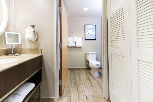 a bathroom with a toilet and a sink at DoubleTree by Hilton Grand Key Resort in Key West