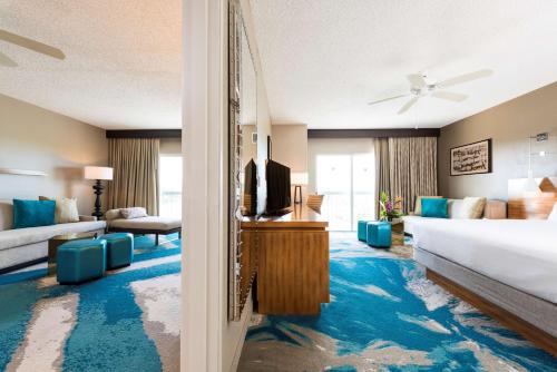 a hotel room with a bed and a tv at DoubleTree by Hilton Grand Key Resort in Key West