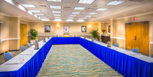 a large conference room with long tables and blue dividers at DoubleTree by Hilton Grand Key Resort in Key West