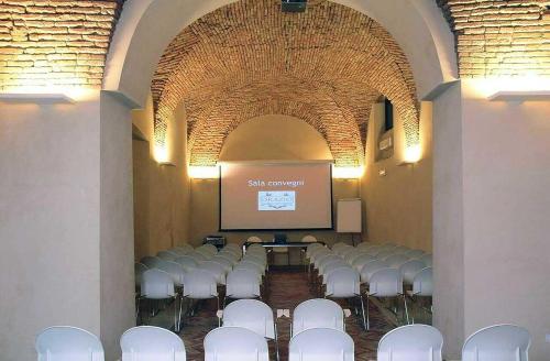 a room with a bunch of chairs and a screen at VenuSuite VENOSA - Luxury House, Spa & Relax - in Venosa