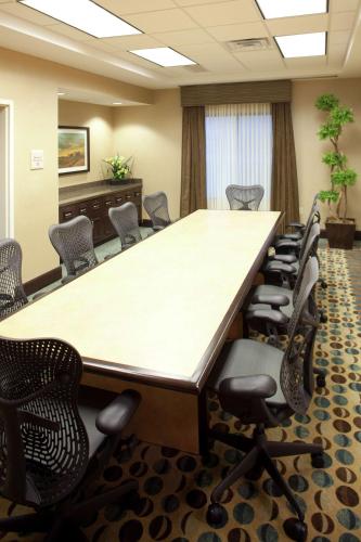 a conference room with a large table and chairs at Hilton Garden Inn Sioux Falls South in Sioux Falls