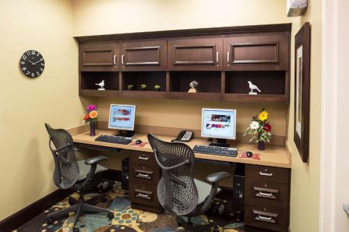 an office with three computers on a desk at Hilton Garden Inn Sioux Falls South in Sioux Falls