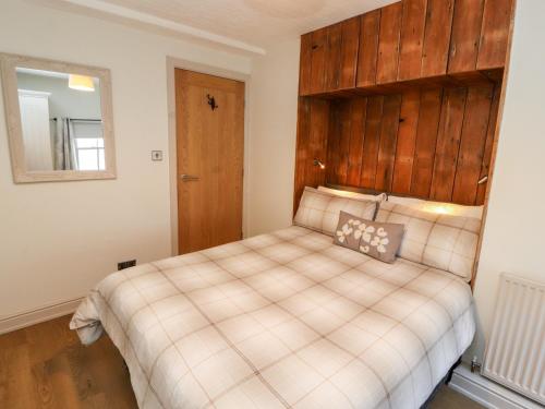 a bedroom with a bed with a wooden headboard at Tawny Owl in Carnforth