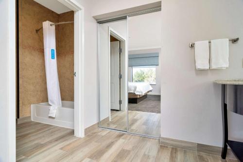 a bathroom with a shower and a glass door at Hampton Inn & Suites Fort Worth-Fossil Creek in Fort Worth
