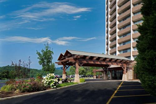 a building with a wooden pavilion next to a road at The Park Vista - A DoubleTree by Hilton Hotel - Gatlinburg in Gatlinburg
