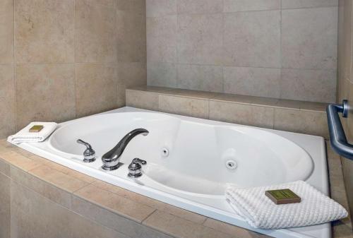 a bath tub with a faucet in a bathroom at DoubleTree by Hilton Grand Junction in Grand Junction