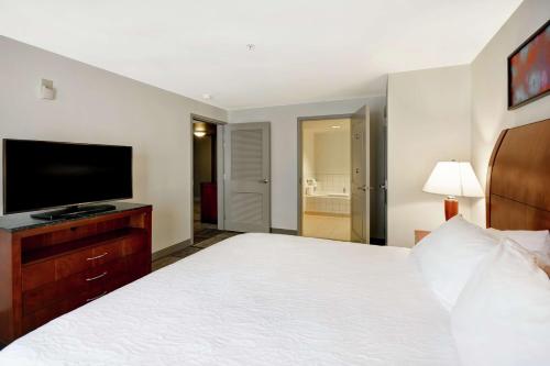 a bedroom with a large bed and a television at Hilton Garden Inn Gulfport - Biloxi Airport in Gulfport