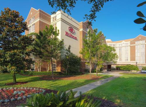 a building with a sign on the side of it at Hilton University of Florida Conference Center Gainesville in Gainesville