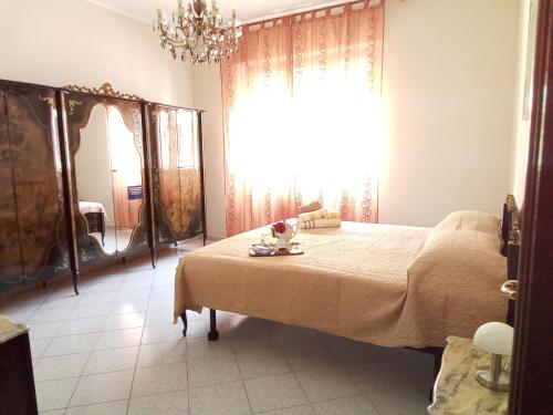 a bedroom with a large bed and a large window at B&B casa Liliana in Turin