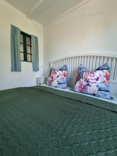 a bedroom with a large bed with two pillows at Ferienhaus Am Fehntjer Tief in Emden