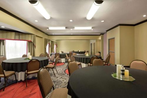 a conference room with black tables and chairs at Hampton Inn and Suites Houston Clear Lake NASA in Webster