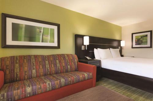 um quarto de hotel com uma cama e um sofá em Hilton Garden Inn Houston Northwest em Houston