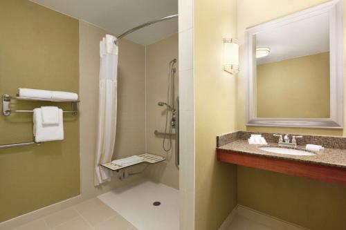 a bathroom with a sink and a shower at Hilton Garden Inn Houston/Clear Lake NASA in Webster
