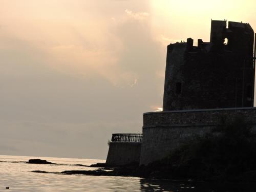 a castle on the shore of the ocean at Domo Dizósa in Siniscola