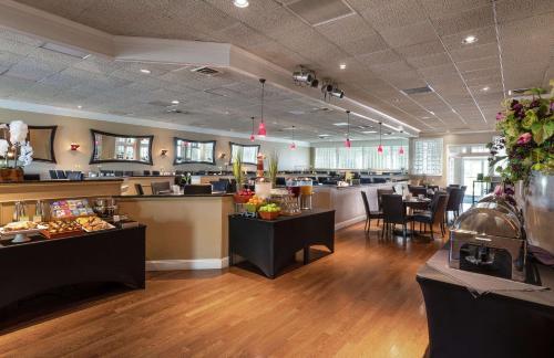 a restaurant with tables and chairs and a cafeteria at DoubleTree by Hilton Cape Cod - Hyannis in Hyannis
