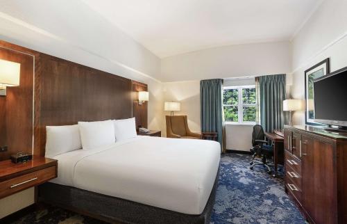 a hotel room with a white bed and a television at DoubleTree by Hilton Cape Cod - Hyannis in Hyannis
