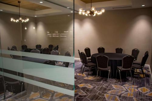 a conference room with a table and chairs at DoubleTree by Hilton Wichita Airport in Wichita