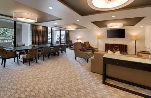 a lobby with a waiting room with tables and chairs at Hilton Houston Post Oak by the Galleria in Houston