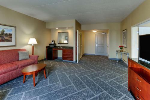 a living room with a couch and a tv at Hilton Garden Inn Indianapolis Airport in Plainfield