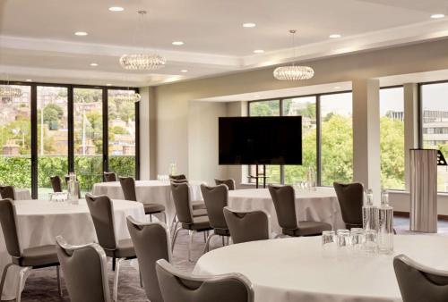 a conference room with tables and chairs and a flat screen tv at DoubleTree by Hilton Lincoln in Lincoln