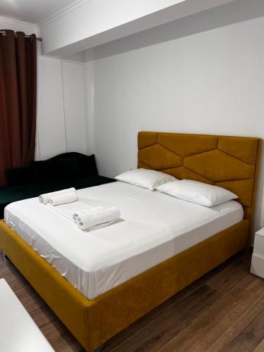 a bedroom with a large bed with two towels on it at The Gwen in Sarandë