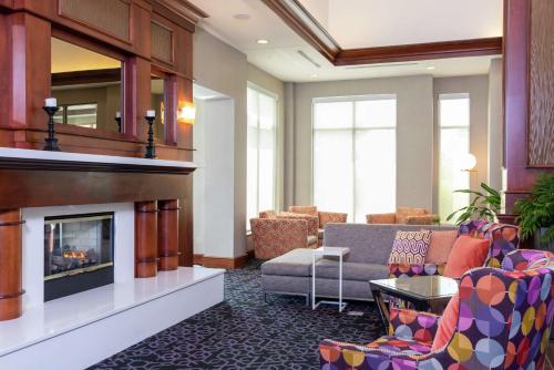 a lobby with a living room with a fireplace at Hilton Garden Inn Indianapolis South/Greenwood in Indianapolis