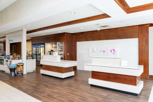 a store lobby with white counters and wood at Hilton Garden Inn Indianapolis South/Greenwood in Indianapolis