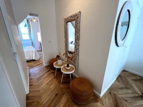 a hallway with a mirror and a table at Le Petit Palais Notre Dame - Heart of Dijon - With AC in Dijon