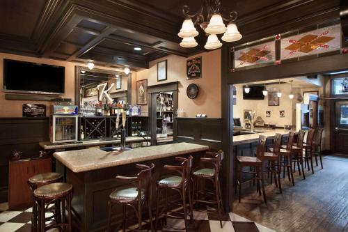 a bar in a restaurant with stools at a counter at Hilton Garden Inn Ithaca in Ithaca