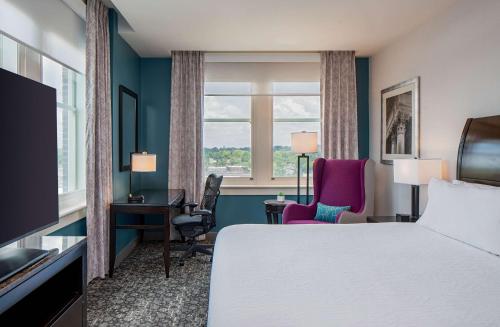 a hotel room with a bed and a window at Hilton Garden Inn Jackson Downtown in Jackson