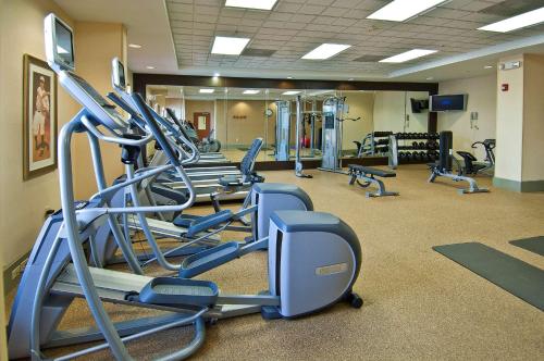 a gym with several treadmills and elliptical machines at Hilton Garden Inn Jackson/Pearl in Pearl