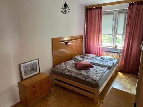 a small bedroom with a bed and a window at Przestronny apartament na wyłączność w centrum miasta - Mszana M11 in Mszana Dolna