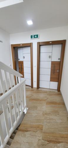 a hallway with three garage doors and a staircase at Apartment Una in Kupres