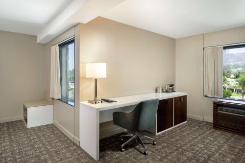 an office with a desk and a chair and a window at DoubleTree by Hilton Monrovia - Pasadena Area in Monrovia