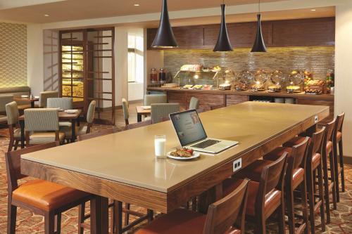 a laptop sitting on a table in a restaurant at DoubleTree by Hilton LAX - El Segundo in El Segundo