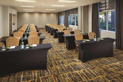 a conference room with rows of tables and chairs at DoubleTree by Hilton LAX - El Segundo in El Segundo