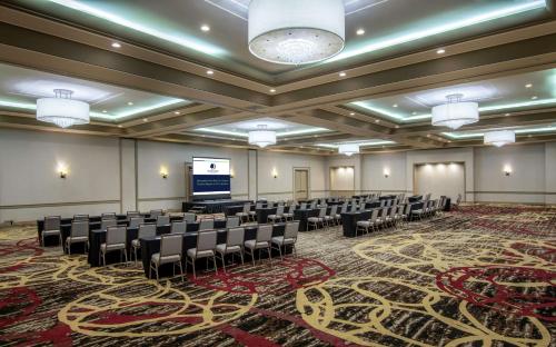 a conference room with chairs and a projection screen at DoubleTree by Hilton Los Angeles Norwalk in Norwalk