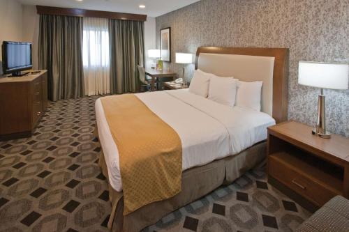 a hotel room with a large bed and a television at DoubleTree by Hilton Rosemead in Rosemead