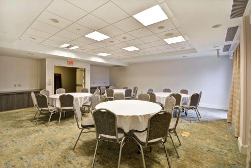 a room with tables and chairs in a room at Hilton Garden Inn Ridgefield Park in Ridgefield Park