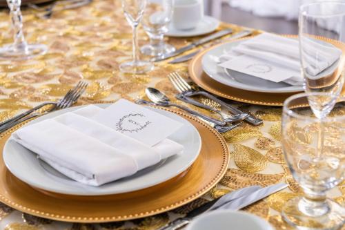 a table with white plates and silverware on a table at DoubleTree by Hilton Carson in Carson