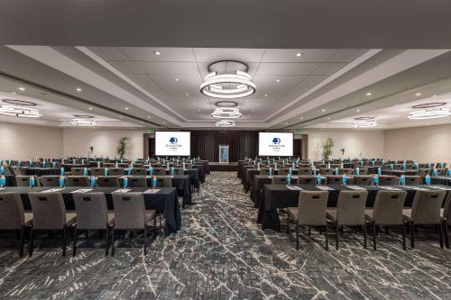 a conference room with rows of tables and chairs at DoubleTree by Hilton Carson in Carson